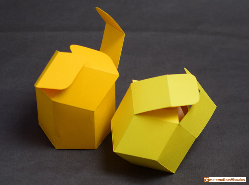 View of two paperboard models (a bee cell and a rhombic dodecahedron) with open tops.